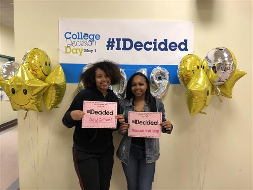 College Decision Day #IDecided, Janiya and another student holding up signs